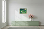 Two girls on swings in a green garden, 72.2 x 50 cm matte canvas print on a natural maple frame, shown at true scale above a sideboard
