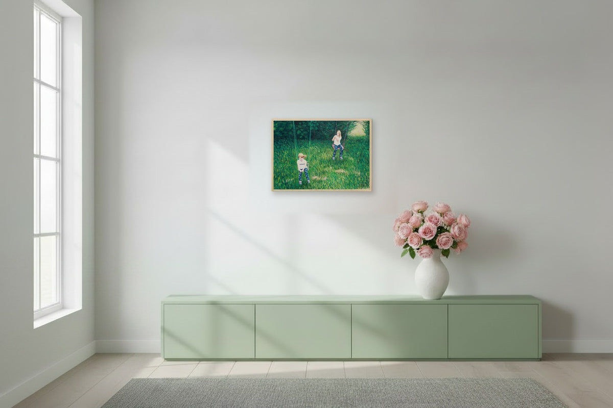 Two girls on swings in a green garden, 72.2 x 50 cm matte canvas print on a natural maple frame, shown at true scale above a sideboard